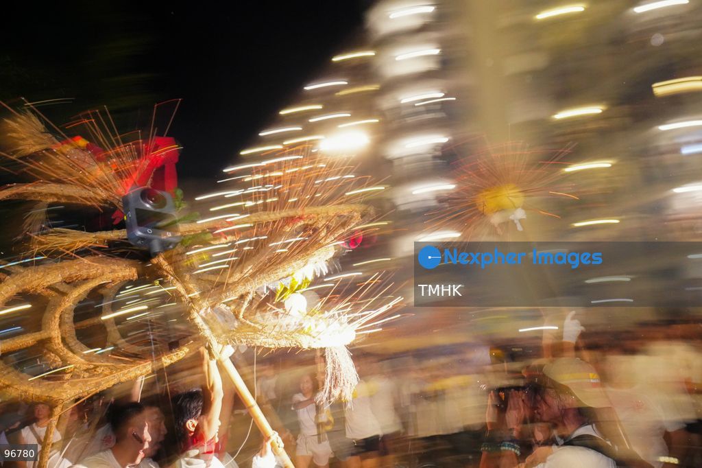 The incense-laden fire dragon weaves through public corridors and plazas of Wah Fu Estate on September 25, 2026 in Hong Kong, surrounded by dense crowds of neighbourhood residents cheering from walkways and balconies ahead of the estate's planned redevelopment. (Photo by Zulu Lo/TMHK via Nexpher Images)