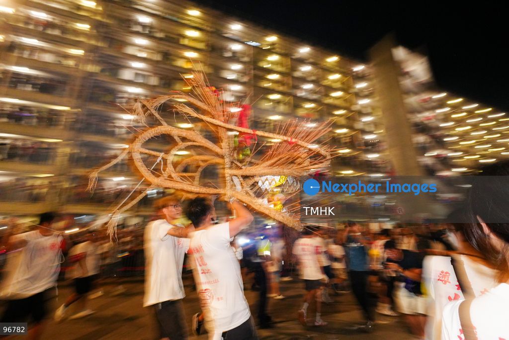 The incense-laden fire dragon weaves through public corridors and plazas of Wah Fu Estate on September 25, 2026 in Hong Kong, surrounded by dense crowds of neighbourhood residents cheering from walkways and balconies ahead of the estate's planned redevelopment. (Photo by Zulu Lo/TMHK via Nexpher Images)