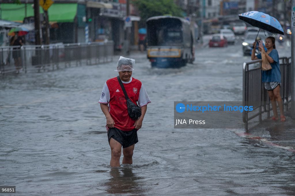 BANGKOK, THAILAND, SEPTEMBER 26, 2026: People and vehicles make their way through flooded streets following heavy rainfall in Bangkok. Thailand has experienced widespread rain as a monsoon trough and low-pressure system affect Bangkok, the Central region and other parts of the country, increasing the risk of flash floods and urban flooding. Photo by Panawat Seangsotg / JNA Press. (Photo by Panawat Seangsotg/JNA Press via Nexpher Images)