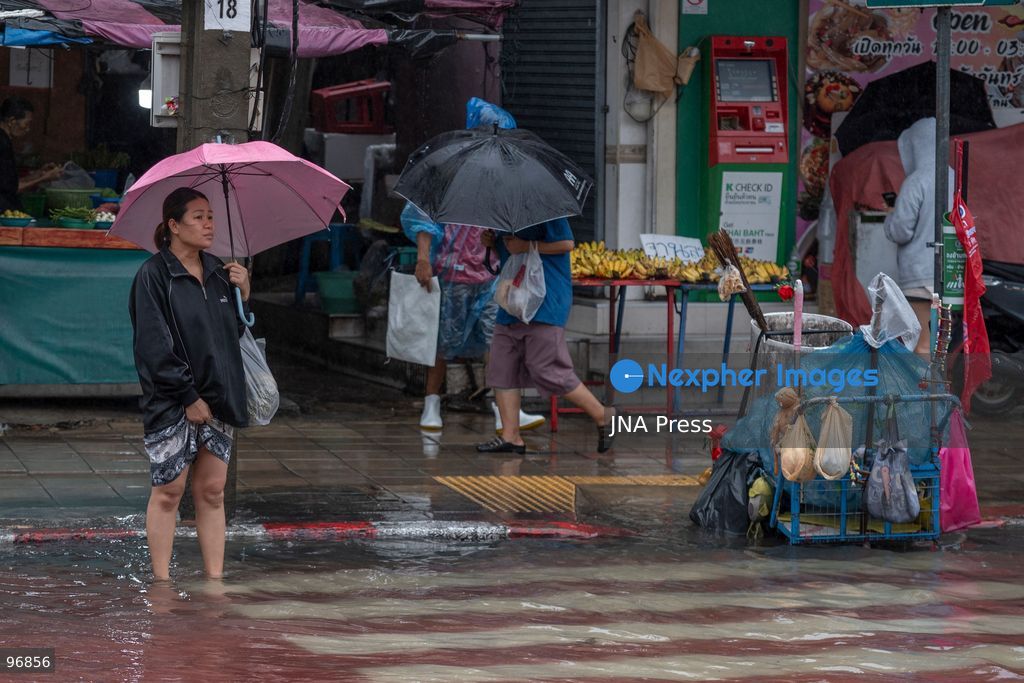 BANGKOK, THAILAND, SEPTEMBER 26, 2026: People and vehicles make their way through flooded streets following heavy rainfall in Bangkok. Thailand has experienced widespread rain as a monsoon trough and low-pressure system affect Bangkok, the Central region and other parts of the country, increasing the risk of flash floods and urban flooding. Photo by Panawat Seangsotg / JNA Press. (Photo by Panawat Seangsotg/JNA Press via Nexpher Images)