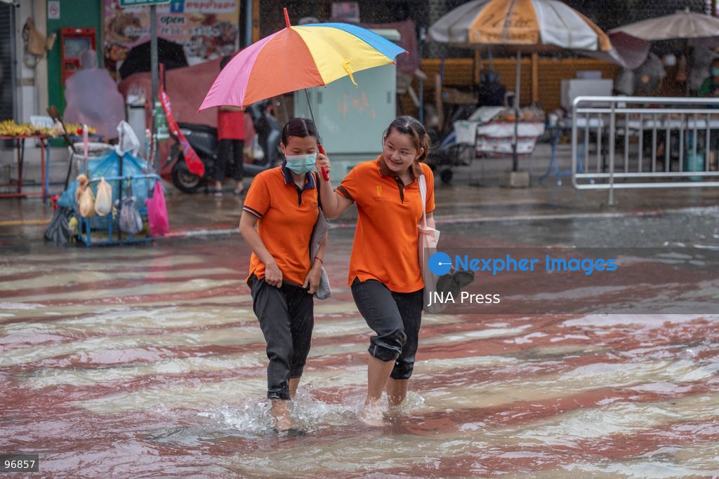 BANGKOK, THAILAND, SEPTEMBER 26, 2026: People and vehicles make their way through flooded streets following heavy rainfall in Bangkok. Thailand has experienced widespread rain as a monsoon trough and low-pressure system affect Bangkok, the Central region and other parts of the country, increasing the risk of flash floods and urban flooding. Photo by Panawat Seangsotg / JNA Press. (Photo by Panawat Seangsotg/JNA Press via Nexpher Images)