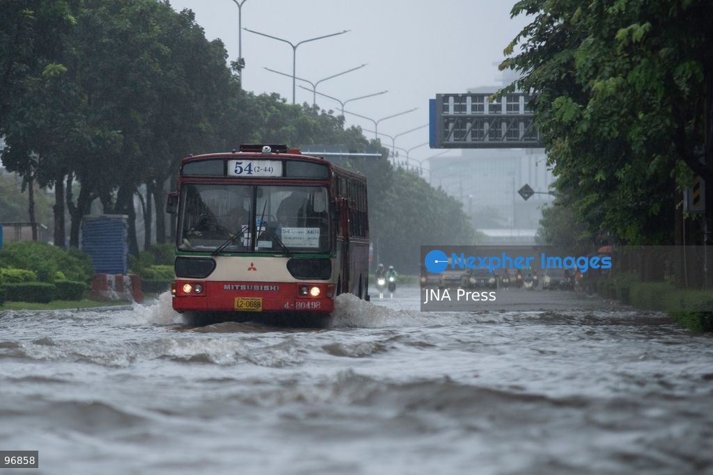 BANGKOK, THAILAND, SEPTEMBER 26, 2026: People and vehicles make their way through flooded streets following heavy rainfall in Bangkok. Thailand has experienced widespread rain as a monsoon trough and low-pressure system affect Bangkok, the Central region and other parts of the country, increasing the risk of flash floods and urban flooding. Photo by Panawat Seangsotg / JNA Press. (Photo by Panawat Seangsotg/JNA Press via Nexpher Images)