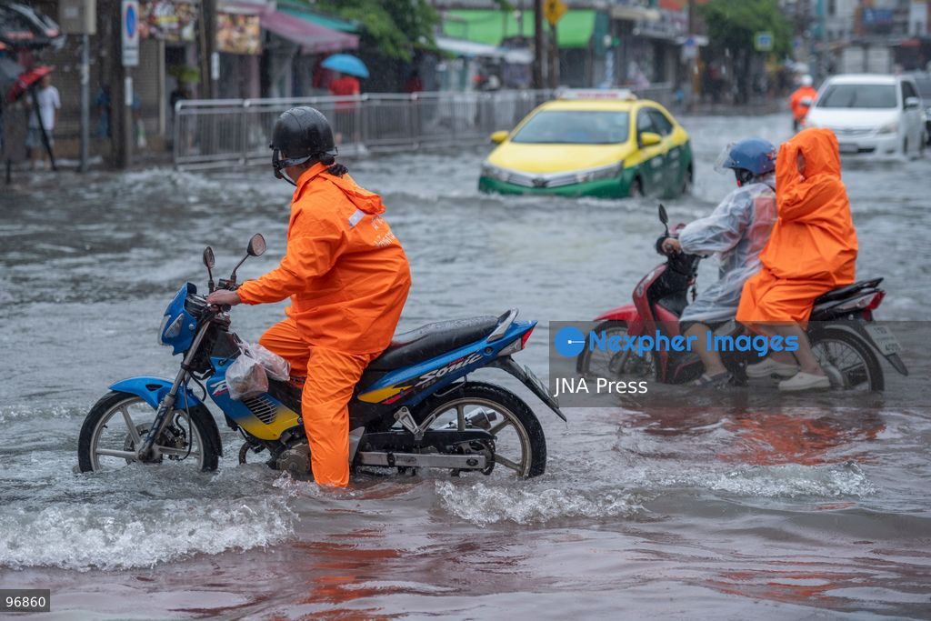 BANGKOK, THAILAND, SEPTEMBER 26, 2026: People and vehicles make their way through flooded streets following heavy rainfall in Bangkok. Thailand has experienced widespread rain as a monsoon trough and low-pressure system affect Bangkok, the Central region and other parts of the country, increasing the risk of flash floods and urban flooding. Photo by Panawat Seangsotg / JNA Press. (Photo by Panawat Seangsotg/JNA Press via Nexpher Images)