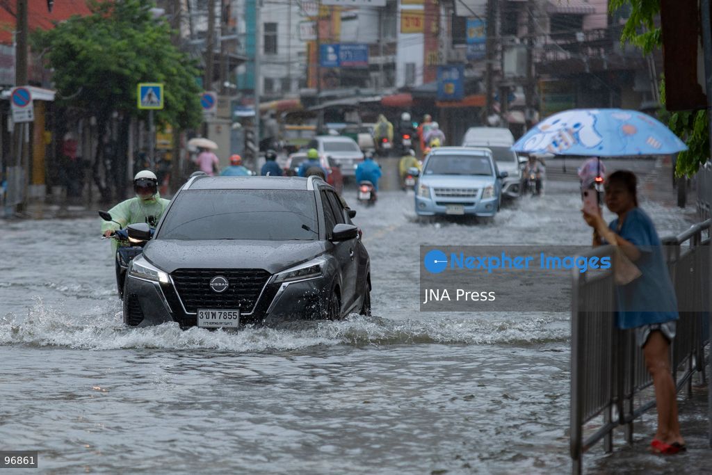 BANGKOK, THAILAND, SEPTEMBER 26, 2026: People and vehicles make their way through flooded streets following heavy rainfall in Bangkok. Thailand has experienced widespread rain as a monsoon trough and low-pressure system affect Bangkok, the Central region and other parts of the country, increasing the risk of flash floods and urban flooding. Photo by Panawat Seangsotg / JNA Press. (Photo by Panawat Seangsotg/JNA Press via Nexpher Images)