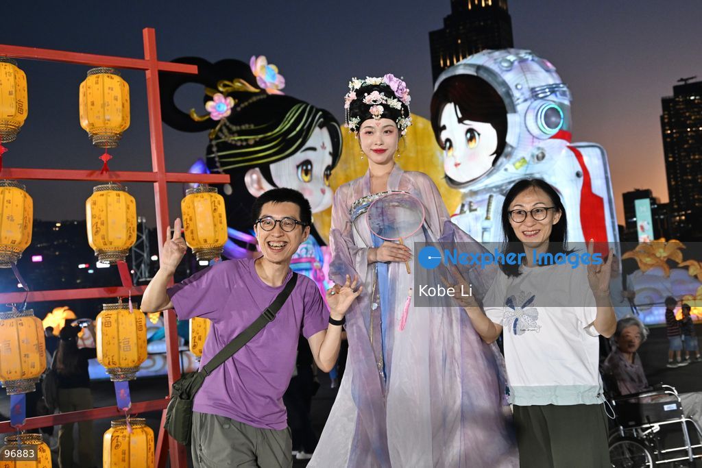 A hanfu tumbler performancer posing photo whith visitors in Hung Hom New Waterfront the day after the Mid-Autumn Festival on September 26, 2026 in Hong Kong. (Photo by Kobe Li/Nexpher Images)