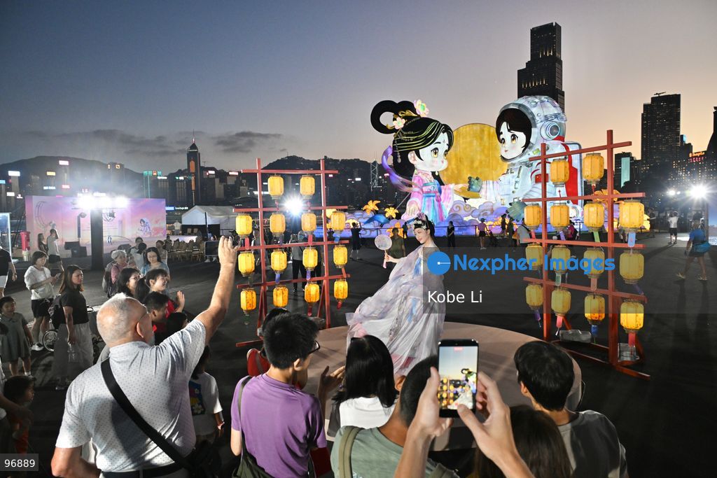 Visitors watch as a performer in traditional Hanfu attire performs in Hung Hom New Waterfront the day after the Mid-Autumn Festival on September 26, 2026 in Hong Kong. (Photo by Kobe Li/Nexpher Images)
