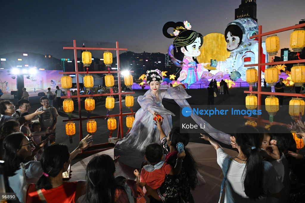 Visitors watch as a performer in traditional Hanfu attire performs in Hung Hom New Waterfront the day after the Mid-Autumn Festival on September 26, 2026 in Hong Kong. (Photo by Kobe Li/Nexpher Images)