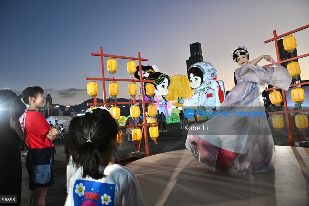 Visitors watch as a performer in traditional Hanfu attire performs in Hung Hom New Waterfront the day after the Mid-Autumn Festival on September 26, 2026 in Hong Kong. (Photo by Kobe Li/Nexpher Images)