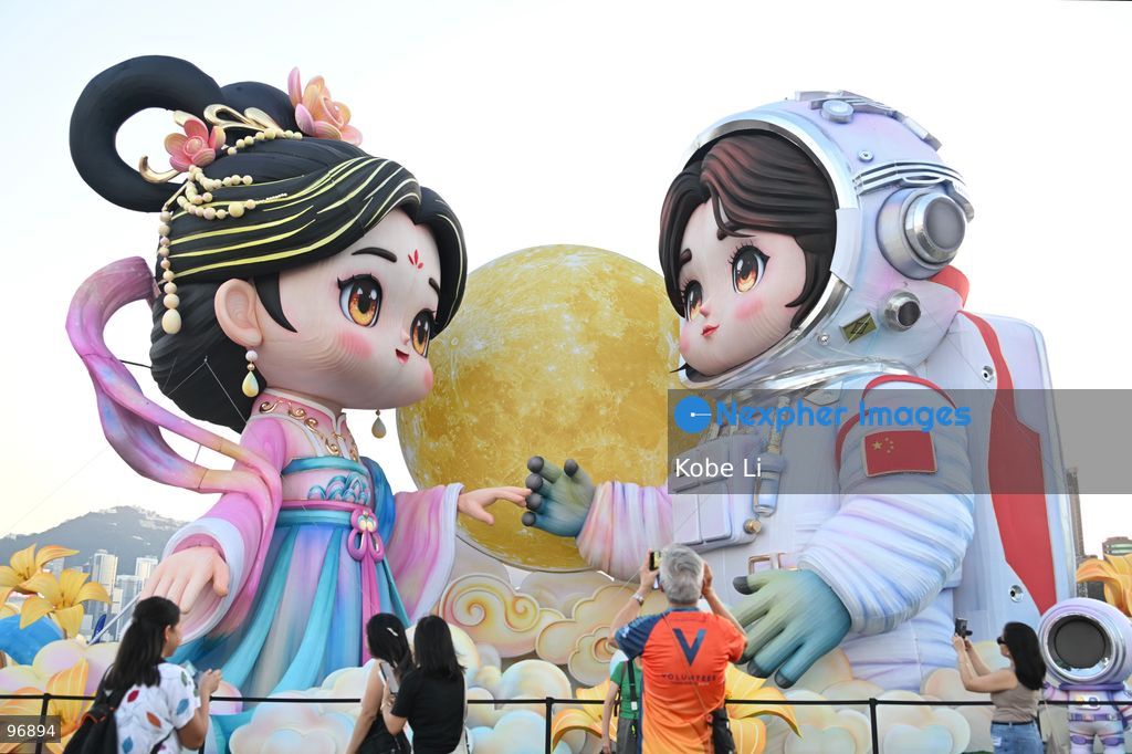 Large illuminated figures depicting a traditional Hanfu and an astronaut are displayed during a nighttime event in Hung Hom New Waterfront, the day after the Mid-Autumn Festival on September 26, 2026 in Hong Kong. (Photo by Kobe Li/Nexpher Images)