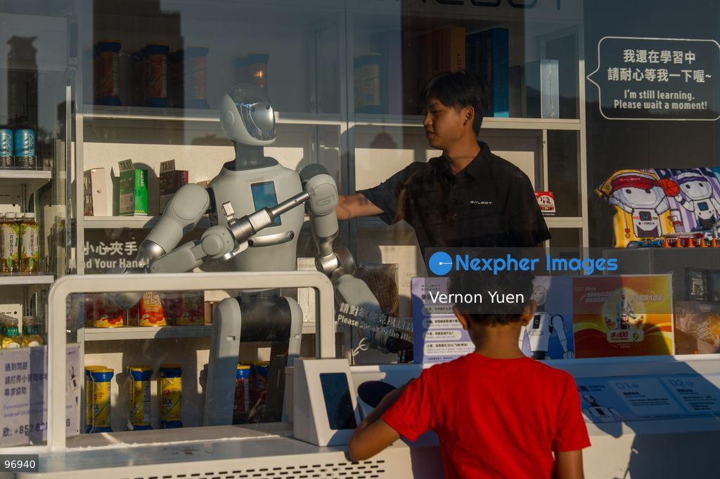 A worker servicing a robot operating a convenience store on September 26, 2026 in Hong Kong. (Photo by Vernon Yuen/Nexpher Images)
