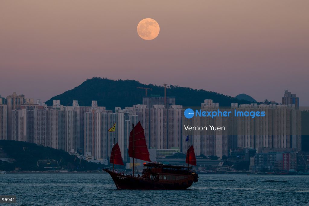 A junk boat sailing in Victoria harbor, a moon rises on September 26, 2026 in Hong Kong. (Photo by Vernon Yuen/Nexpher Images)