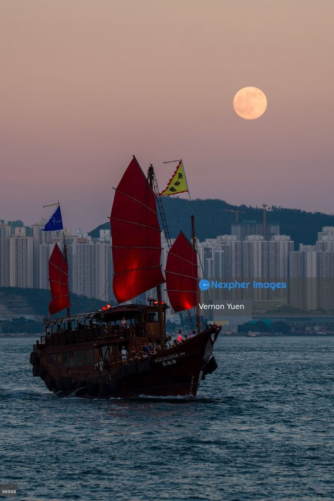 A junk boat sailing in Victoria harbor, a moon rises on September 26, 2026 in Hong Kong. (Photo by Vernon Yuen/Nexpher Images)