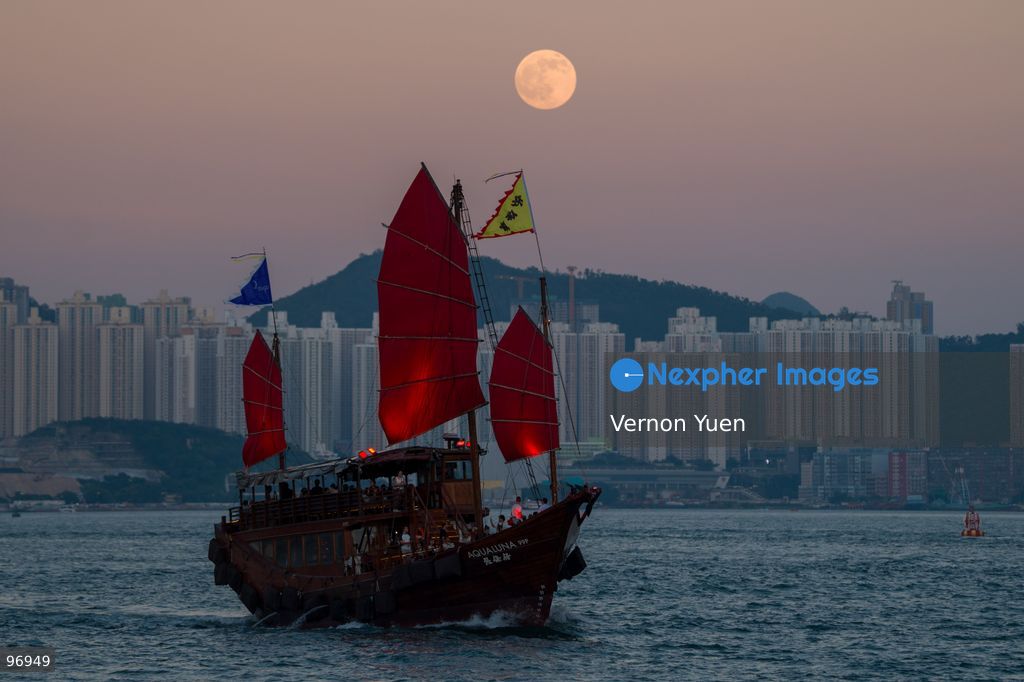 A junk boat sailing in Victoria harbor, a moon rises on September 26, 2026 in Hong Kong. (Photo by Vernon Yuen/Nexpher Images)