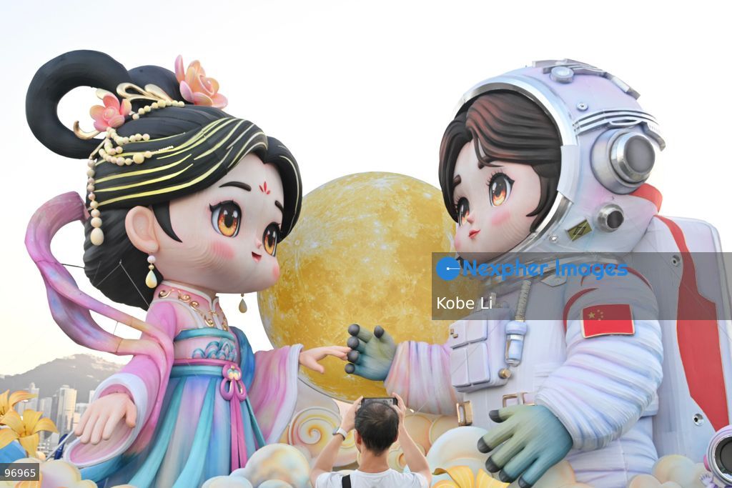 Large illuminated figures depicting a traditional Hanfu and an astronaut are displayed during a nighttime event in Hung Hom New Waterfront, the day after the Mid-Autumn Festival on September 26, 2026 in Hong Kong. (Photo by Kobe Li/Nexpher Images)