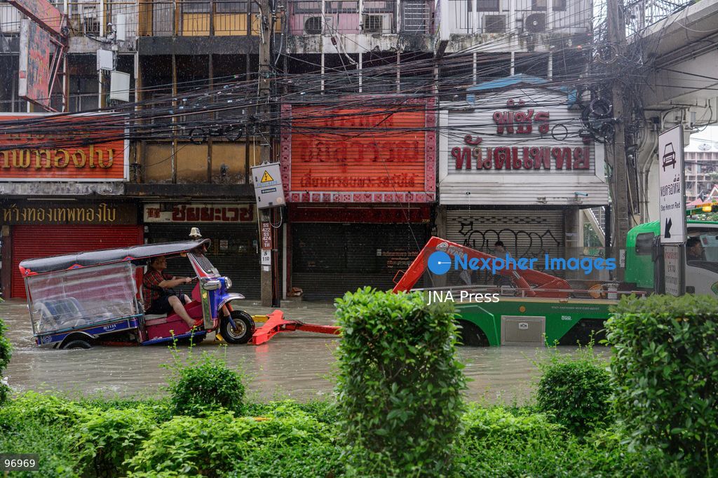 BANGKOK, THAILAND, SEPTEMBER 26, 2026: Residents navigate flooded streets amid persistent heavy rain in Bangkok, Thailand. Continuous rainfall since September 24 caused widespread flooding across the capital, with nearly 300 millimeters of rain recorded in some areas. Bangkok authorities declared all 50 districts disaster-affected as floodwaters disrupted roads and residential communities. More heavy rain was forecast through September 27. Photo by Watsawat Koktabtim (Photo by Watsawat Koktabtim/JNA Press via Nexpher Images)