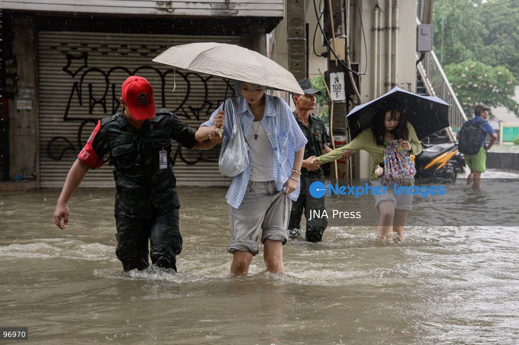 BANGKOK, THAILAND, SEPTEMBER 26, 2026: Residents navigate flooded streets amid persistent heavy rain in Bangkok, Thailand. Continuous rainfall since September 24 caused widespread flooding across the capital, with nearly 300 millimeters of rain recorded in some areas. Bangkok authorities declared all 50 districts disaster-affected as floodwaters disrupted roads and residential communities. More heavy rain was forecast through September 27. Photo by Watsawat Koktabtim (Photo by Watsawat Koktabtim/JNA Press via Nexpher Images)