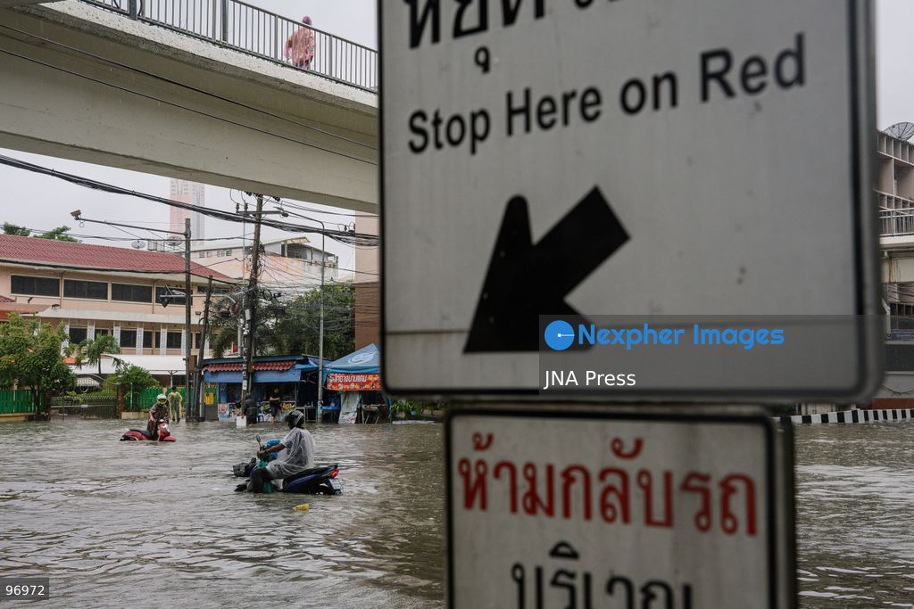 BANGKOK, THAILAND, SEPTEMBER 26, 2026: Residents navigate flooded streets amid persistent heavy rain in Bangkok, Thailand. Continuous rainfall since September 24 caused widespread flooding across the capital, with nearly 300 millimeters of rain recorded in some areas. Bangkok authorities declared all 50 districts disaster-affected as floodwaters disrupted roads and residential communities. More heavy rain was forecast through September 27. Photo by Watsawat Koktabtim (Photo by Watsawat Koktabtim/JNA Press via Nexpher Images)