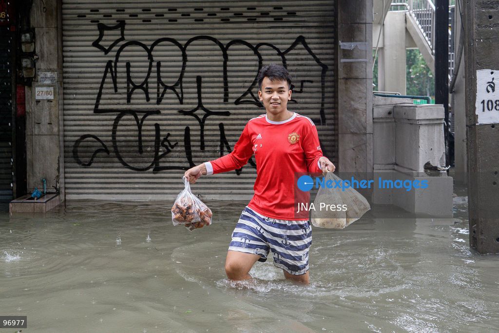 BANGKOK, THAILAND, SEPTEMBER 26, 2026: Residents navigate flooded streets amid persistent heavy rain in Bangkok, Thailand. Continuous rainfall since September 24 caused widespread flooding across the capital, with nearly 300 millimeters of rain recorded in some areas. Bangkok authorities declared all 50 districts disaster-affected as floodwaters disrupted roads and residential communities. More heavy rain was forecast through September 27. Photo by Watsawat Koktabtim (Photo by Watsawat Koktabtim/JNA Press via Nexpher Images)