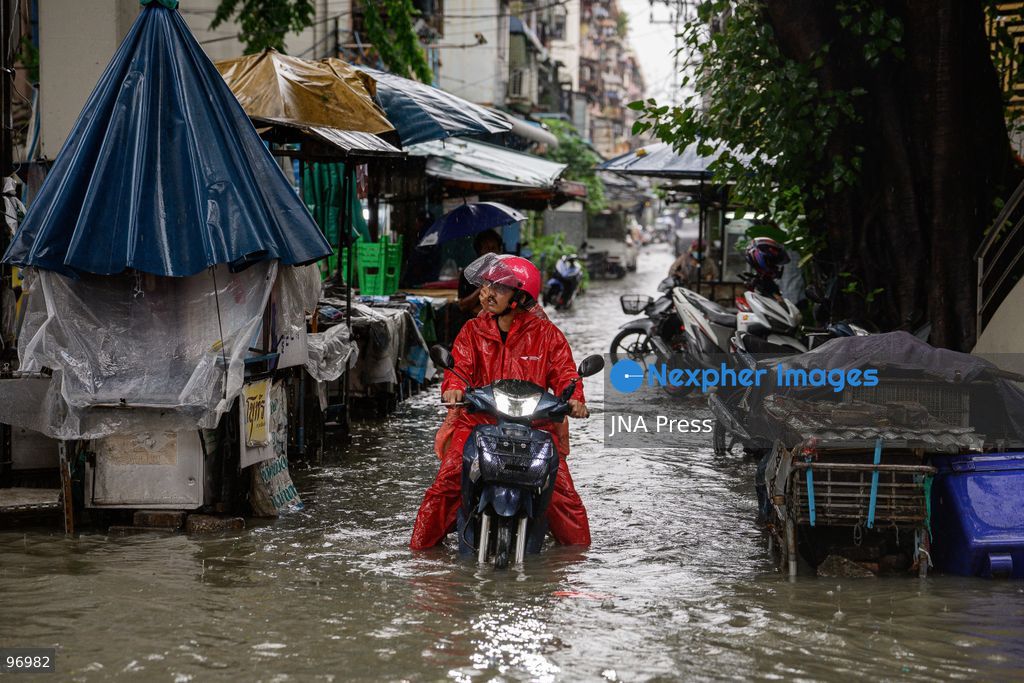 BANGKOK, THAILAND, SEPTEMBER 26, 2026: Residents navigate flooded streets amid persistent heavy rain in Bangkok, Thailand. Continuous rainfall since September 24 caused widespread flooding across the capital, with nearly 300 millimeters of rain recorded in some areas. Bangkok authorities declared all 50 districts disaster-affected as floodwaters disrupted roads and residential communities. More heavy rain was forecast through September 27. Photo by Watsawat Koktabtim (Photo by Watsawat Koktabtim/JNA Press via Nexpher Images)