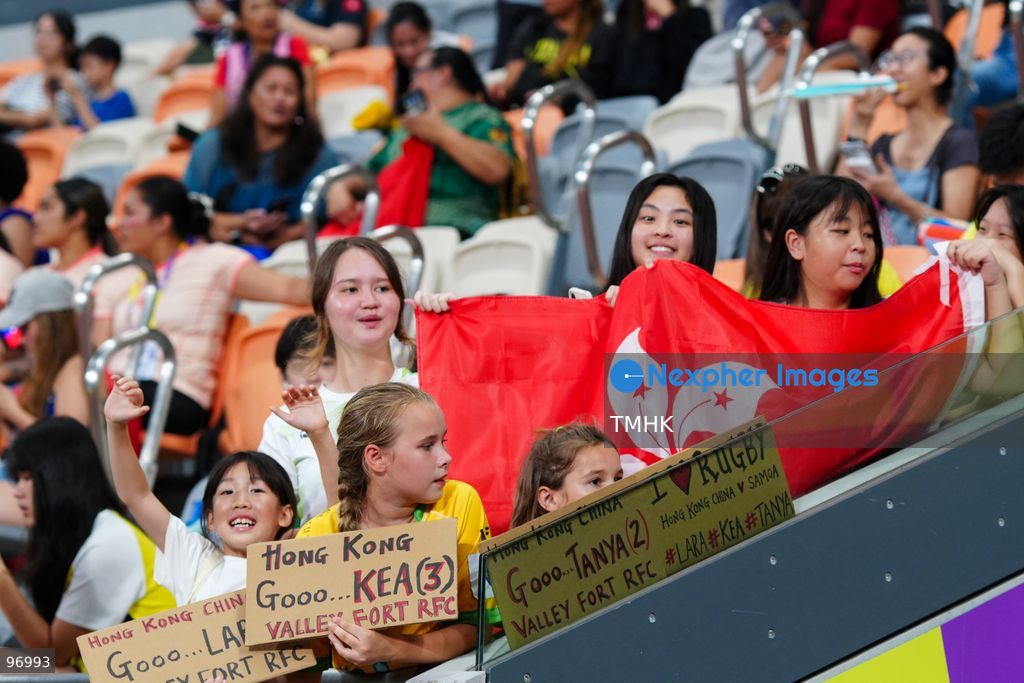 Spectators wave flags and cheer from the stands during the WXV 3 rugby tournament match between Hong Kong, China and Samoa at Kai Tak Youth Sports Ground on September 26, 2026 in Hong Kong. Despite high temperatures and a five-hour schedule delay, passionate fans filled the venue to support the home team in the tournament finale. (Photo by Zulu Lo/TMHK via Nexpher Images)