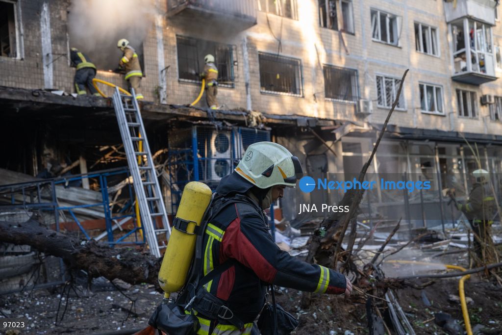KYIV, UKRAINE, SEPTEMBER 26, 2026: Firefighters work at a five-story residential building damaged during a Russian drone attack in Kyiv’s Solomianskyi district, as residents watch emergency operations and clear shattered glass from the area. Kyiv authorities said a fire broke out at the residential building and a ground-floor shop following the fall of a drone, injuring four people and prompting rescuers to evacuate 20 residents. Photo by Nastasssia Torres / JNA Press. (Photo by Nastassia Kantorowicz Torres/JNA Press via Nexpher Images)