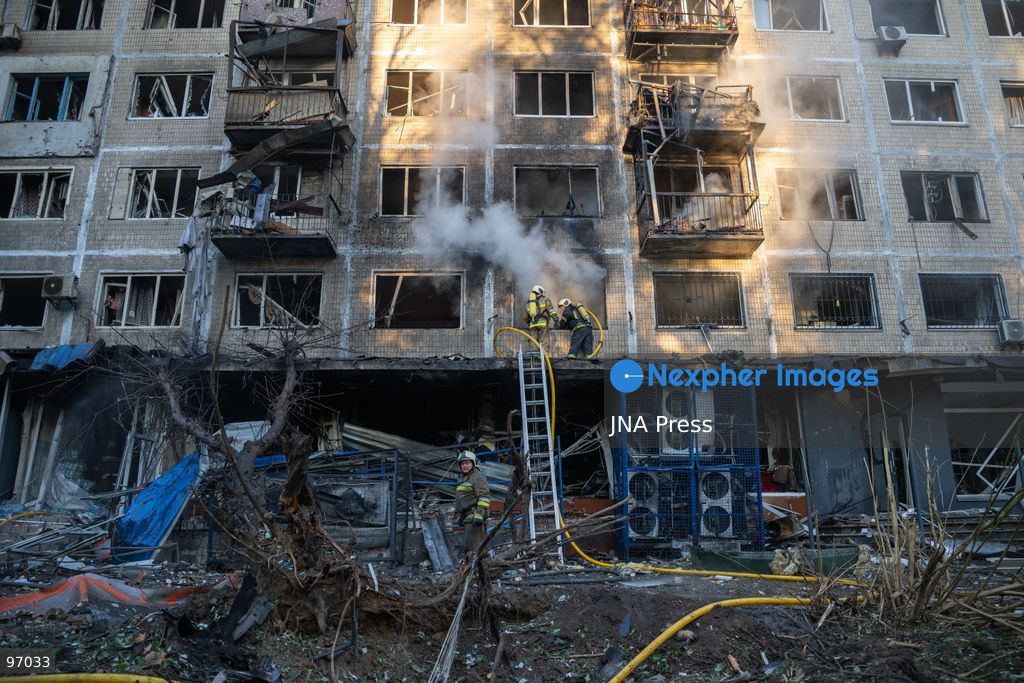 KYIV, UKRAINE, SEPTEMBER 26, 2026: Firefighters work at a five-story residential building damaged during a Russian drone attack in Kyiv’s Solomianskyi district, as residents watch emergency operations and clear shattered glass from the area. Kyiv authorities said a fire broke out at the residential building and a ground-floor shop following the fall of a drone, injuring four people and prompting rescuers to evacuate 20 residents. Photo by Nastasssia Torres / JNA Press. (Photo by Nastassia Kantorowicz Torres/JNA Press via Nexpher Images)