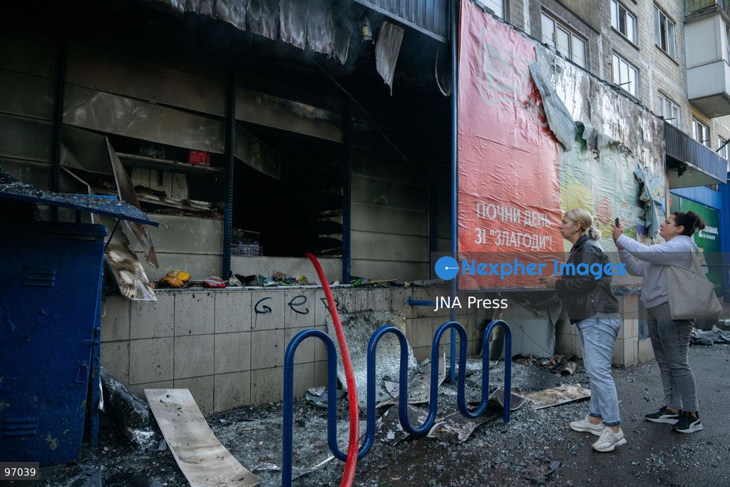 KYIV, UKRAINE, SEPTEMBER 26, 2026: Firefighters work at a five-story residential building damaged during a Russian drone attack in Kyiv’s Solomianskyi district, as residents watch emergency operations and clear shattered glass from the area. Kyiv authorities said a fire broke out at the residential building and a ground-floor shop following the fall of a drone, injuring four people and prompting rescuers to evacuate 20 residents. Photo by Nastasssia Torres / JNA Press. (Photo by Nastassia Kantorowicz Torres/JNA Press via Nexpher Images)