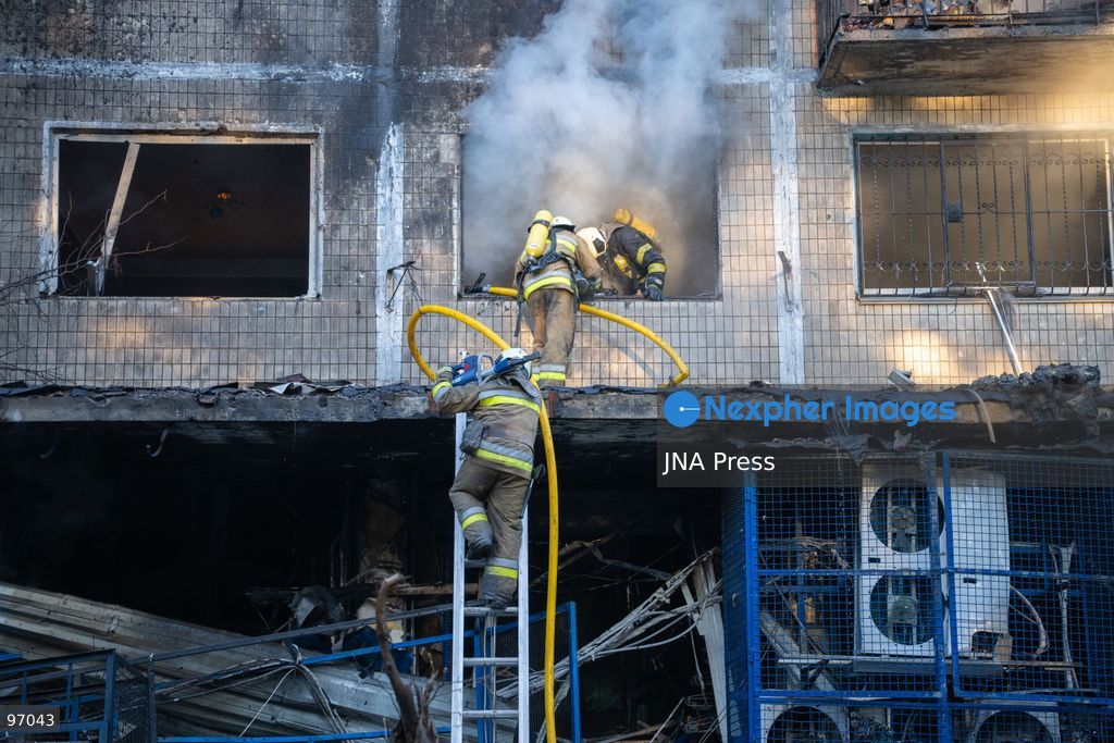KYIV, UKRAINE, SEPTEMBER 26, 2026: Firefighters work at a five-story residential building damaged during a Russian drone attack in Kyiv’s Solomianskyi district, as residents watch emergency operations and clear shattered glass from the area. Kyiv authorities said a fire broke out at the residential building and a ground-floor shop following the fall of a drone, injuring four people and prompting rescuers to evacuate 20 residents. Photo by Nastasssia Torres / JNA Press. (Photo by Nastassia Kantorowicz Torres/JNA Press via Nexpher Images)