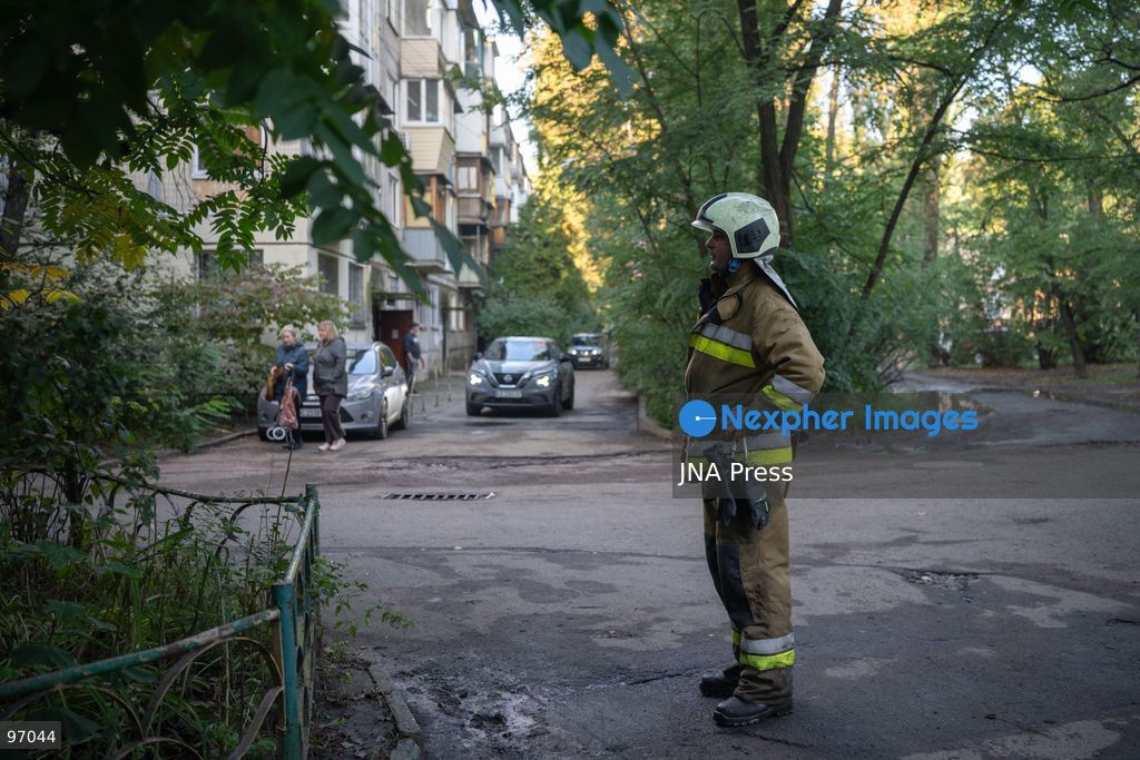 KYIV, UKRAINE, SEPTEMBER 26, 2026: Firefighters work at a five-story residential building damaged during a Russian drone attack in Kyiv’s Solomianskyi district, as residents watch emergency operations and clear shattered glass from the area. Kyiv authorities said a fire broke out at the residential building and a ground-floor shop following the fall of a drone, injuring four people and prompting rescuers to evacuate 20 residents. Photo by Nastasssia Torres / JNA Press. (Photo by Nastassia Kantorowicz Torres/JNA Press via Nexpher Images)