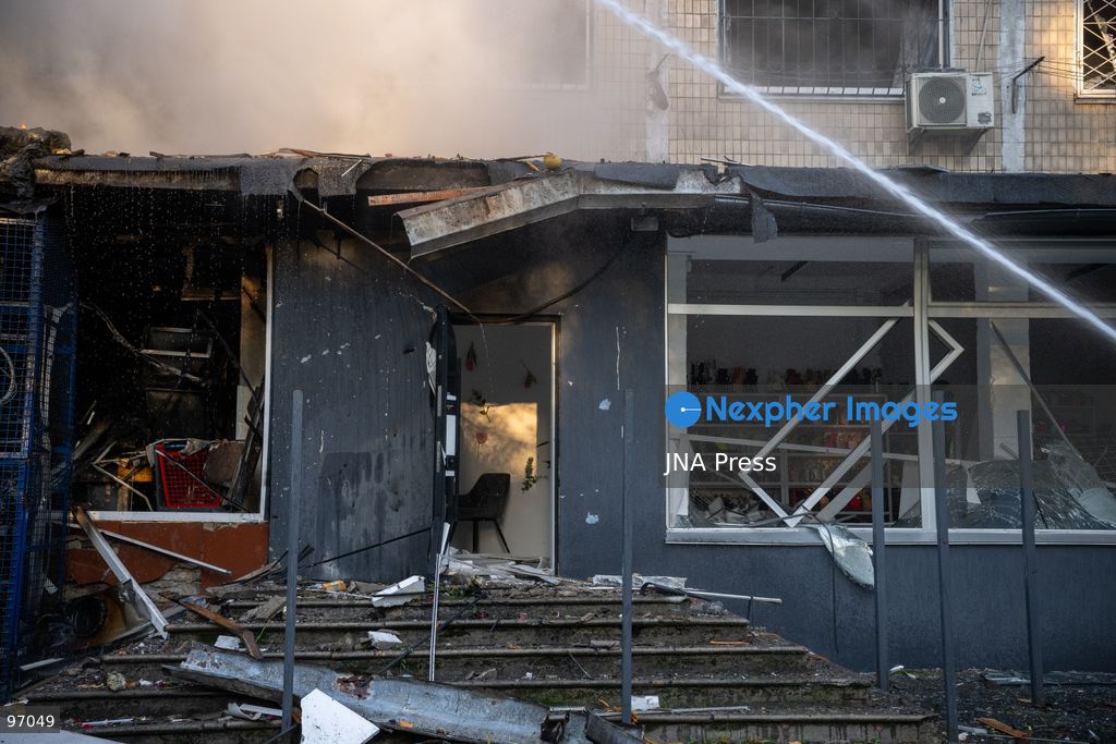 KYIV, UKRAINE, SEPTEMBER 26, 2026: Firefighters work at a five-story residential building damaged during a Russian drone attack in Kyiv’s Solomianskyi district, as residents watch emergency operations and clear shattered glass from the area. Kyiv authorities said a fire broke out at the residential building and a ground-floor shop following the fall of a drone, injuring four people and prompting rescuers to evacuate 20 residents. Photo by Nastasssia Torres / JNA Press. (Photo by Nastassia Kantorowicz Torres/JNA Press via Nexpher Images)