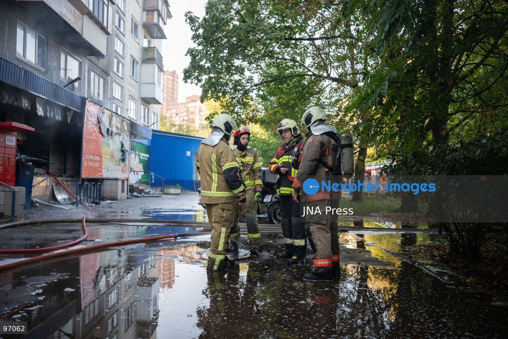 KYIV, UKRAINE, SEPTEMBER 26, 2026: Firefighters work at a five-story residential building damaged during a Russian drone attack in Kyiv’s Solomianskyi district, as residents watch emergency operations and clear shattered glass from the area. Kyiv authorities said a fire broke out at the residential building and a ground-floor shop following the fall of a drone, injuring four people and prompting rescuers to evacuate 20 residents. Photo by Nastasssia Torres / JNA Press. (Photo by Nastassia Kantorowicz Torres/JNA Press via Nexpher Images)