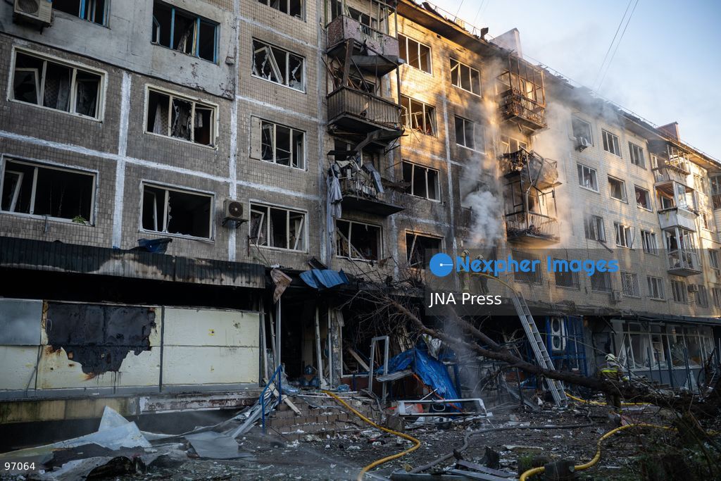 KYIV, UKRAINE, SEPTEMBER 26, 2026: Firefighters work at a five-story residential building damaged during a Russian drone attack in Kyiv’s Solomianskyi district, as residents watch emergency operations and clear shattered glass from the area. Kyiv authorities said a fire broke out at the residential building and a ground-floor shop following the fall of a drone, injuring four people and prompting rescuers to evacuate 20 residents. Photo by Nastasssia Torres / JNA Press. (Photo by Nastassia Kantorowicz Torres/JNA Press via Nexpher Images)