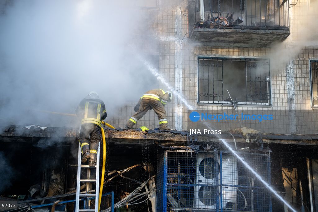 KYIV, UKRAINE, SEPTEMBER 26, 2026: Firefighters work at a five-story residential building damaged during a Russian drone attack in Kyiv’s Solomianskyi district, as residents watch emergency operations and clear shattered glass from the area. Kyiv authorities said a fire broke out at the residential building and a ground-floor shop following the fall of a drone, injuring four people and prompting rescuers to evacuate 20 residents. Photo by Nastasssia Torres / JNA Press. (Photo by Nastassia Kantorowicz Torres/JNA Press via Nexpher Images)