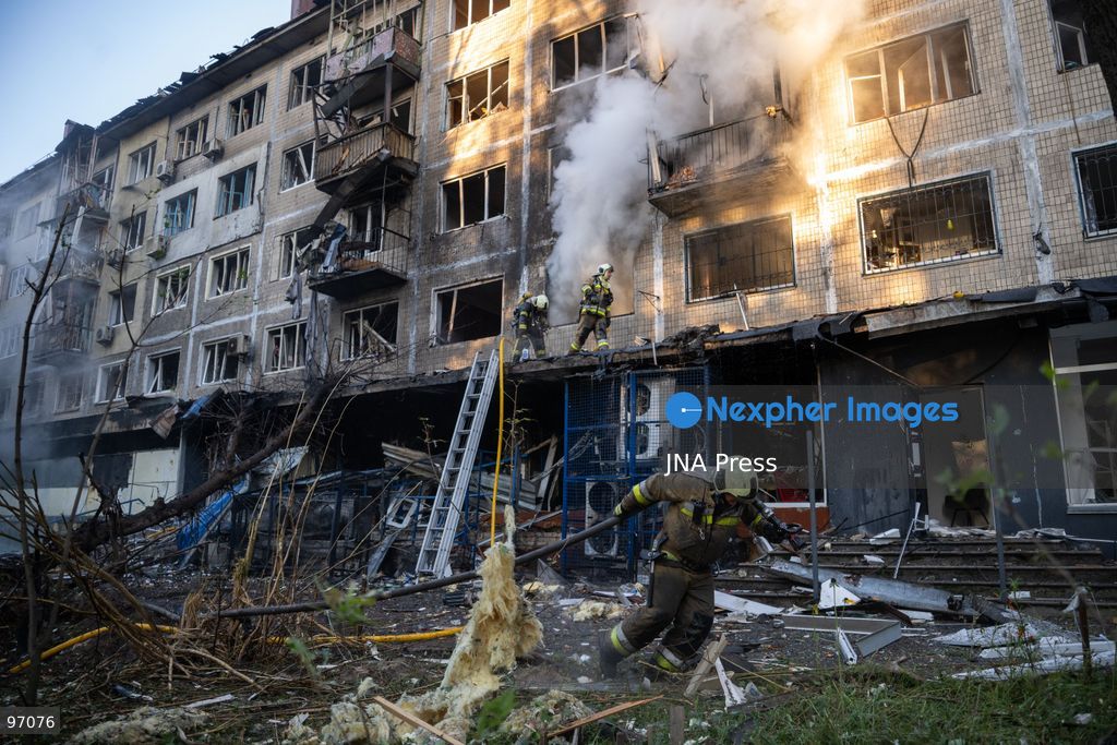KYIV, UKRAINE, SEPTEMBER 26, 2026: Firefighters work at a five-story residential building damaged during a Russian drone attack in Kyiv’s Solomianskyi district, as residents watch emergency operations and clear shattered glass from the area. Kyiv authorities said a fire broke out at the residential building and a ground-floor shop following the fall of a drone, injuring four people and prompting rescuers to evacuate 20 residents. Photo by Nastasssia Torres / JNA Press. (Photo by Nastassia Kantorowicz Torres/JNA Press via Nexpher Images)