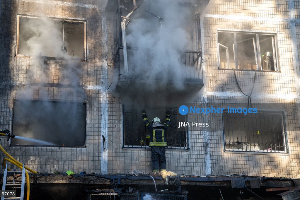 KYIV, UKRAINE, SEPTEMBER 26, 2026: Firefighters work at a five-story residential building damaged during a Russian drone attack in Kyiv’s Solomianskyi district, as residents watch emergency operations and clear shattered glass from the area. Kyiv authorities said a fire broke out at the residential building and a ground-floor shop following the fall of a drone, injuring four people and prompting rescuers to evacuate 20 residents. Photo by Nastasssia Torres / JNA Press. (Photo by Nastassia Kantorowicz Torres/JNA Press via Nexpher Images)