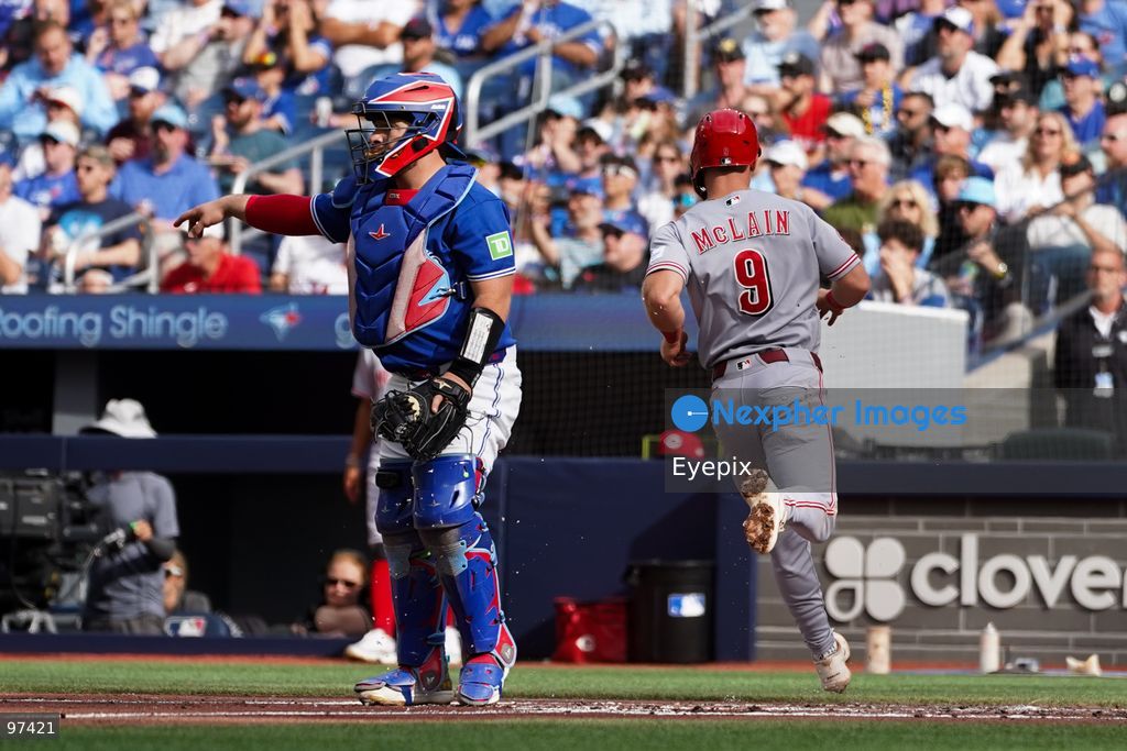 Toronto Blue Jays catcher Alejandro Kirk #30 gestures during a play as Matt McLain #9 of the Cincinnati Reds runs the baseline during the regular season MLB game at Rogers Centre on September 26, 2026, in Toronto, Ontario, Canada. (Photo by Leonardo Ramirez/ Eyepix Group) (Photo by Leonardo Ramirez/ Eyepix Group/Eyepix via Nexpher Images)