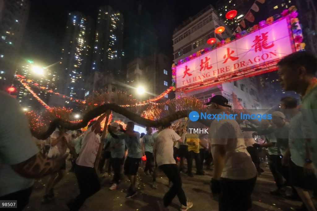 Performers and villagers hoist the incense-laden fire dragon to depart from Tai Hang on the final leg of its festive parade on September 26, 2026 in Hong Kong. Held on the "Chasing the Moon" night, the team sets off through local streets towards the Causeway Bay Typhoon Shelter for the culminating "Dragon Returning to the Sea" ritual, marking the grand finale of the event's 147th anniversary. (Photo by Gordon Choi/TMHK via Nexpher Images)