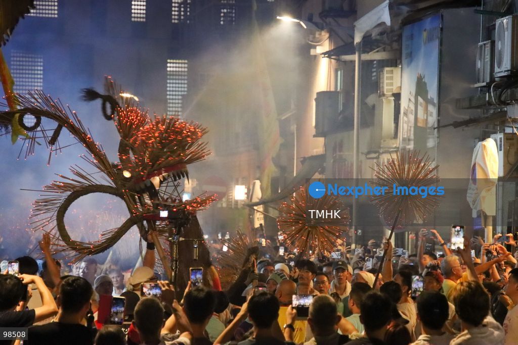 Performers and villagers hoist the incense-laden fire dragon to depart from Tai Hang on the final leg of its festive parade on September 26, 2026 in Hong Kong. Held on the "Chasing the Moon" night, the team sets off through local streets towards the Causeway Bay Typhoon Shelter for the culminating "Dragon Returning to the Sea" ritual, marking the grand finale of the event's 147th anniversary. (Photo by Gordon Choi/TMHK via Nexpher Images)