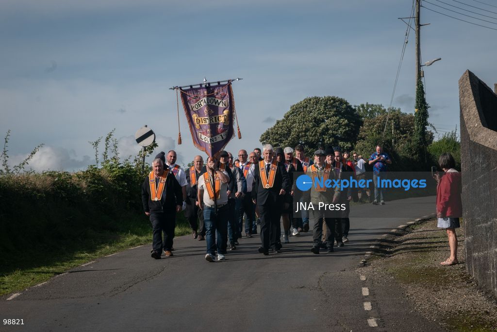 PORTADOWN, NORTHERN IRELAND, SEPTEMBER 28, 2026: Members of the Orange Order gather near Drumcree Parish Church as a standoff over the contentious Drumcree parade continues in Portadown. The Protestant fraternal organization had been granted conditional permission to march along the predominantly nationalist Garvaghy Road for the first time in nearly three decades, but the route was blocked by thousands of protesters and police prevented the parade from proceeding amid public safety concerns. On Monday, residents continued gathering on Garvaghy Road while Orange Order members remained near Drumcree Church as discussions continued with police and officials over the dispute. Photo by Nadia Caimi / JNA Press. (Photo by Nadia Caimi/JNA Press via Nexpher Images)
