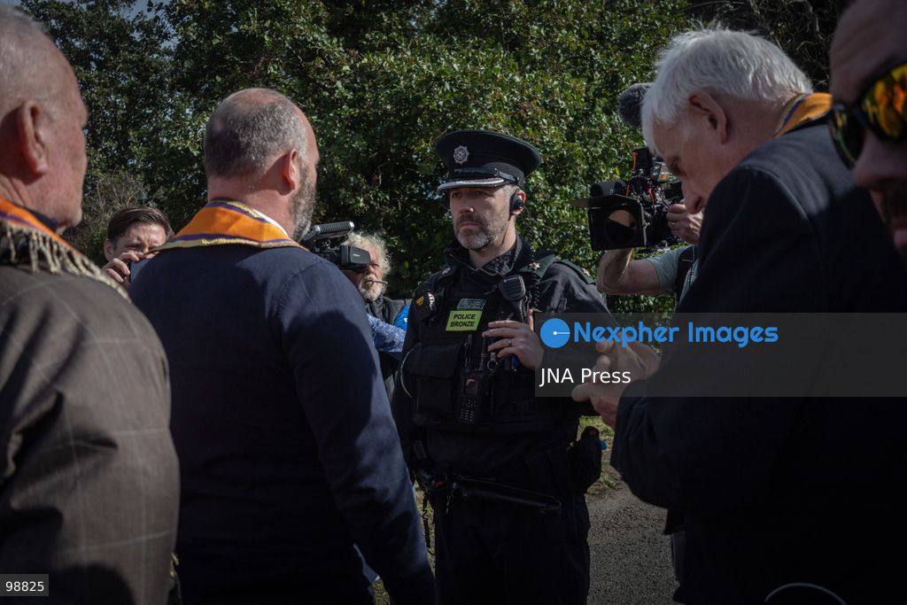 PORTADOWN, NORTHERN IRELAND, SEPTEMBER 28, 2026: Members of the Orange Order gather near Drumcree Parish Church as a standoff over the contentious Drumcree parade continues in Portadown. The Protestant fraternal organization had been granted conditional permission to march along the predominantly nationalist Garvaghy Road for the first time in nearly three decades, but the route was blocked by thousands of protesters and police prevented the parade from proceeding amid public safety concerns. On Monday, residents continued gathering on Garvaghy Road while Orange Order members remained near Drumcree Church as discussions continued with police and officials over the dispute. Photo by Nadia Caimi / JNA Press. (Photo by Nadia Caimi/JNA Press via Nexpher Images)