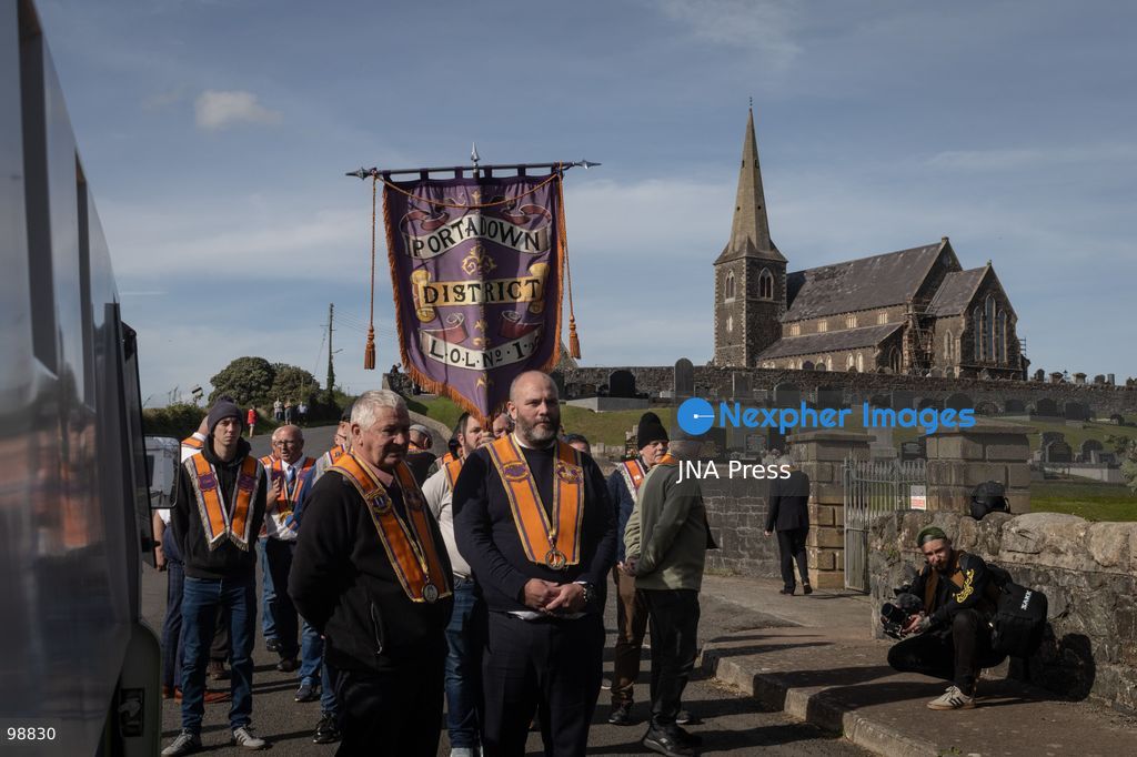 PORTADOWN, NORTHERN IRELAND, SEPTEMBER 28, 2026: Members of the Orange Order gather near Drumcree Parish Church as a standoff over the contentious Drumcree parade continues in Portadown. The Protestant fraternal organization had been granted conditional permission to march along the predominantly nationalist Garvaghy Road for the first time in nearly three decades, but the route was blocked by thousands of protesters and police prevented the parade from proceeding amid public safety concerns. On Monday, residents continued gathering on Garvaghy Road while Orange Order members remained near Drumcree Church as discussions continued with police and officials over the dispute. Photo by Nadia Caimi / JNA Press. (Photo by Nadia Caimi/JNA Press via Nexpher Images)