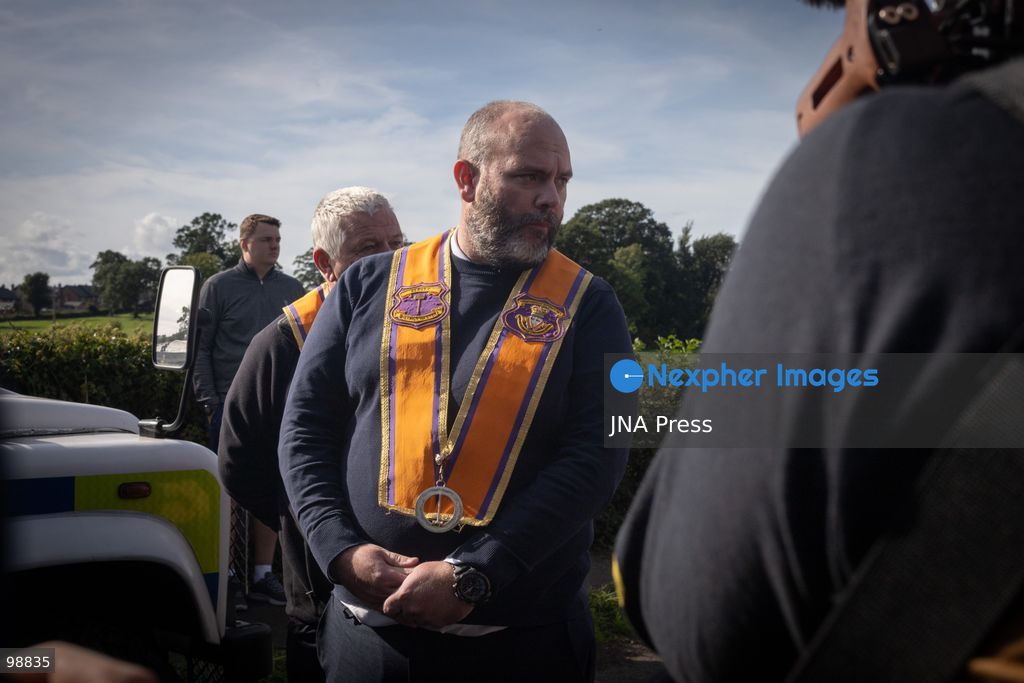 PORTADOWN, NORTHERN IRELAND, SEPTEMBER 28, 2026: Members of the Orange Order gather near Drumcree Parish Church as a standoff over the contentious Drumcree parade continues in Portadown. The Protestant fraternal organization had been granted conditional permission to march along the predominantly nationalist Garvaghy Road for the first time in nearly three decades, but the route was blocked by thousands of protesters and police prevented the parade from proceeding amid public safety concerns. On Monday, residents continued gathering on Garvaghy Road while Orange Order members remained near Drumcree Church as discussions continued with police and officials over the dispute. Photo by Nadia Caimi / JNA Press. (Photo by Nadia Caimi/JNA Press via Nexpher Images)