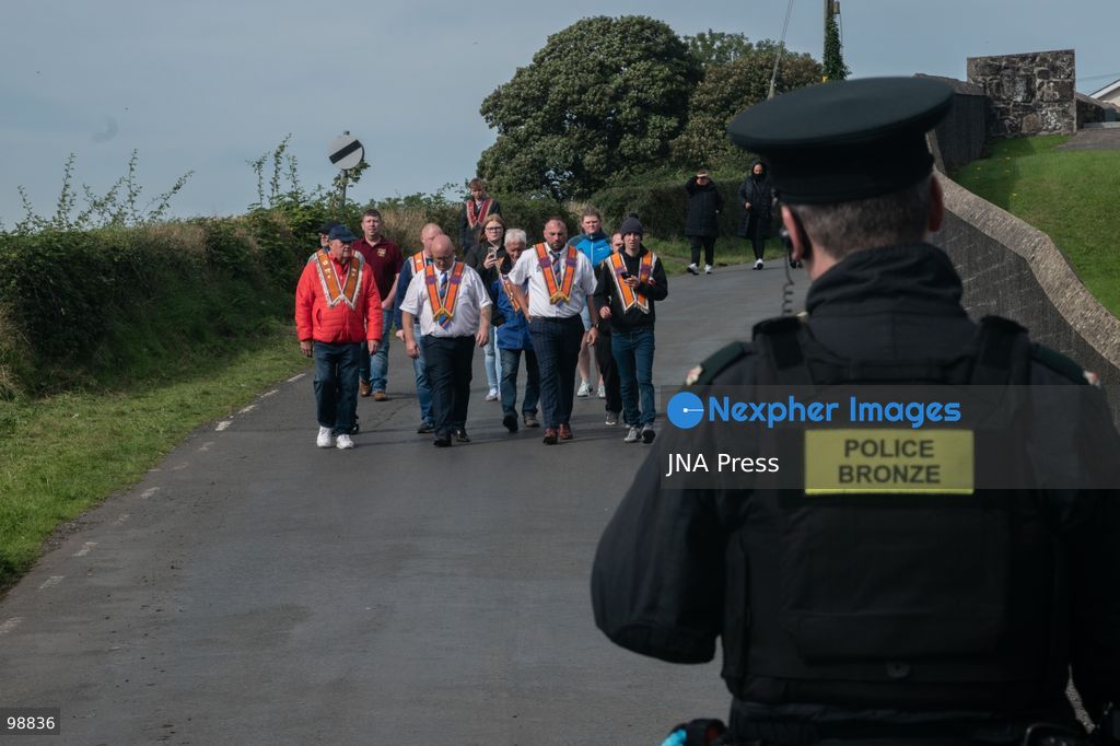 PORTADOWN, NORTHERN IRELAND, SEPTEMBER 28, 2026: Members of the Orange Order gather near Drumcree Parish Church as a standoff over the contentious Drumcree parade continues in Portadown. The Protestant fraternal organization had been granted conditional permission to march along the predominantly nationalist Garvaghy Road for the first time in nearly three decades, but the route was blocked by thousands of protesters and police prevented the parade from proceeding amid public safety concerns. On Monday, residents continued gathering on Garvaghy Road while Orange Order members remained near Drumcree Church as discussions continued with police and officials over the dispute. Photo by Nadia Caimi / JNA Press. (Photo by Nadia Caimi/JNA Press via Nexpher Images)