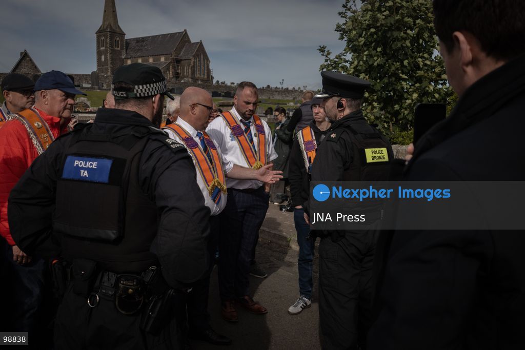 PORTADOWN, NORTHERN IRELAND, SEPTEMBER 28, 2026: Members of the Orange Order gather near Drumcree Parish Church as a standoff over the contentious Drumcree parade continues in Portadown. The Protestant fraternal organization had been granted conditional permission to march along the predominantly nationalist Garvaghy Road for the first time in nearly three decades, but the route was blocked by thousands of protesters and police prevented the parade from proceeding amid public safety concerns. On Monday, residents continued gathering on Garvaghy Road while Orange Order members remained near Drumcree Church as discussions continued with police and officials over the dispute. Photo by Nadia Caimi / JNA Press. (Photo by Nadia Caimi/JNA Press via Nexpher Images)
