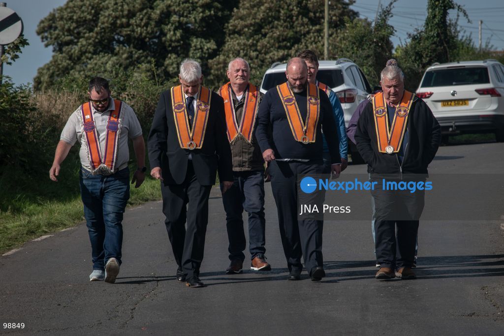 PORTADOWN, NORTHERN IRELAND, SEPTEMBER 28, 2026: Members of the Orange Order gather near Drumcree Parish Church as a standoff over the contentious Drumcree parade continues in Portadown. The Protestant fraternal organization had been granted conditional permission to march along the predominantly nationalist Garvaghy Road for the first time in nearly three decades, but the route was blocked by thousands of protesters and police prevented the parade from proceeding amid public safety concerns. On Monday, residents continued gathering on Garvaghy Road while Orange Order members remained near Drumcree Church as discussions continued with police and officials over the dispute. Photo by Nadia Caimi / JNA Press. (Photo by Nadia Caimi/JNA Press via Nexpher Images)