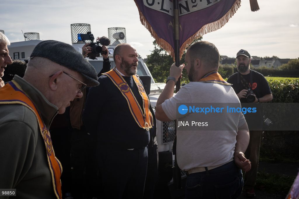 PORTADOWN, NORTHERN IRELAND, SEPTEMBER 28, 2026: Members of the Orange Order gather near Drumcree Parish Church as a standoff over the contentious Drumcree parade continues in Portadown. The Protestant fraternal organization had been granted conditional permission to march along the predominantly nationalist Garvaghy Road for the first time in nearly three decades, but the route was blocked by thousands of protesters and police prevented the parade from proceeding amid public safety concerns. On Monday, residents continued gathering on Garvaghy Road while Orange Order members remained near Drumcree Church as discussions continued with police and officials over the dispute. Photo by Nadia Caimi / JNA Press. (Photo by Nadia Caimi/JNA Press via Nexpher Images)