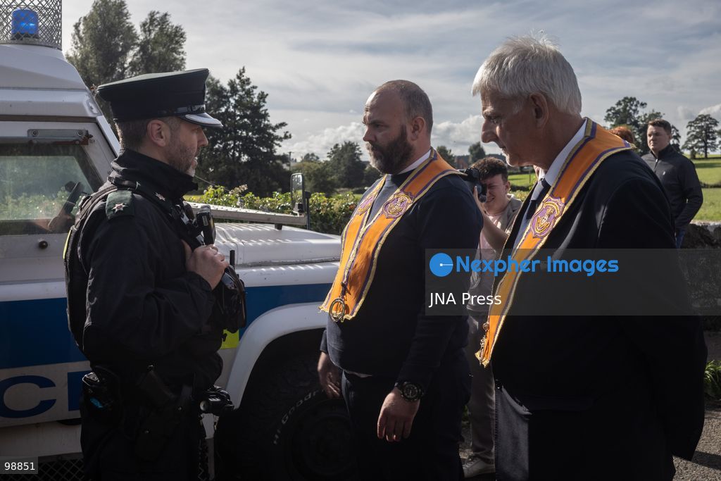 PORTADOWN, NORTHERN IRELAND, SEPTEMBER 28, 2026: Members of the Orange Order gather near Drumcree Parish Church as a standoff over the contentious Drumcree parade continues in Portadown. The Protestant fraternal organization had been granted conditional permission to march along the predominantly nationalist Garvaghy Road for the first time in nearly three decades, but the route was blocked by thousands of protesters and police prevented the parade from proceeding amid public safety concerns. On Monday, residents continued gathering on Garvaghy Road while Orange Order members remained near Drumcree Church as discussions continued with police and officials over the dispute. Photo by Nadia Caimi / JNA Press. (Photo by Nadia Caimi/JNA Press via Nexpher Images)