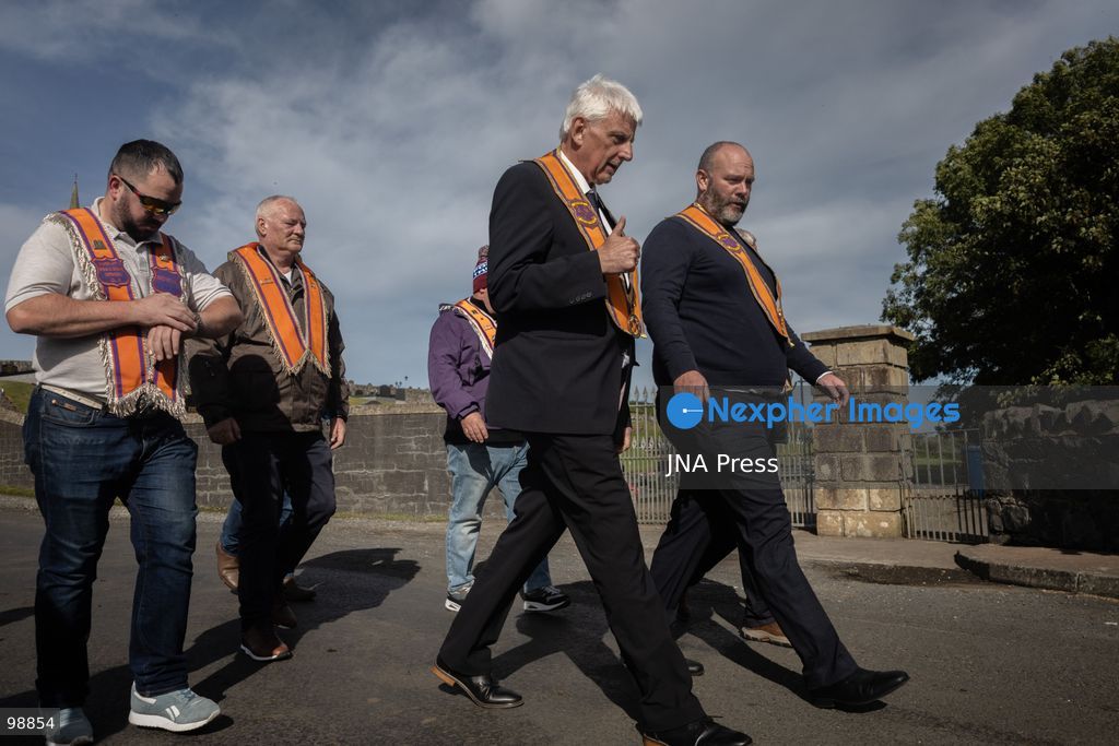 PORTADOWN, NORTHERN IRELAND, SEPTEMBER 28, 2026: Members of the Orange Order gather near Drumcree Parish Church as a standoff over the contentious Drumcree parade continues in Portadown. The Protestant fraternal organization had been granted conditional permission to march along the predominantly nationalist Garvaghy Road for the first time in nearly three decades, but the route was blocked by thousands of protesters and police prevented the parade from proceeding amid public safety concerns. On Monday, residents continued gathering on Garvaghy Road while Orange Order members remained near Drumcree Church as discussions continued with police and officials over the dispute. Photo by Nadia Caimi / JNA Press. (Photo by Nadia Caimi/JNA Press via Nexpher Images)