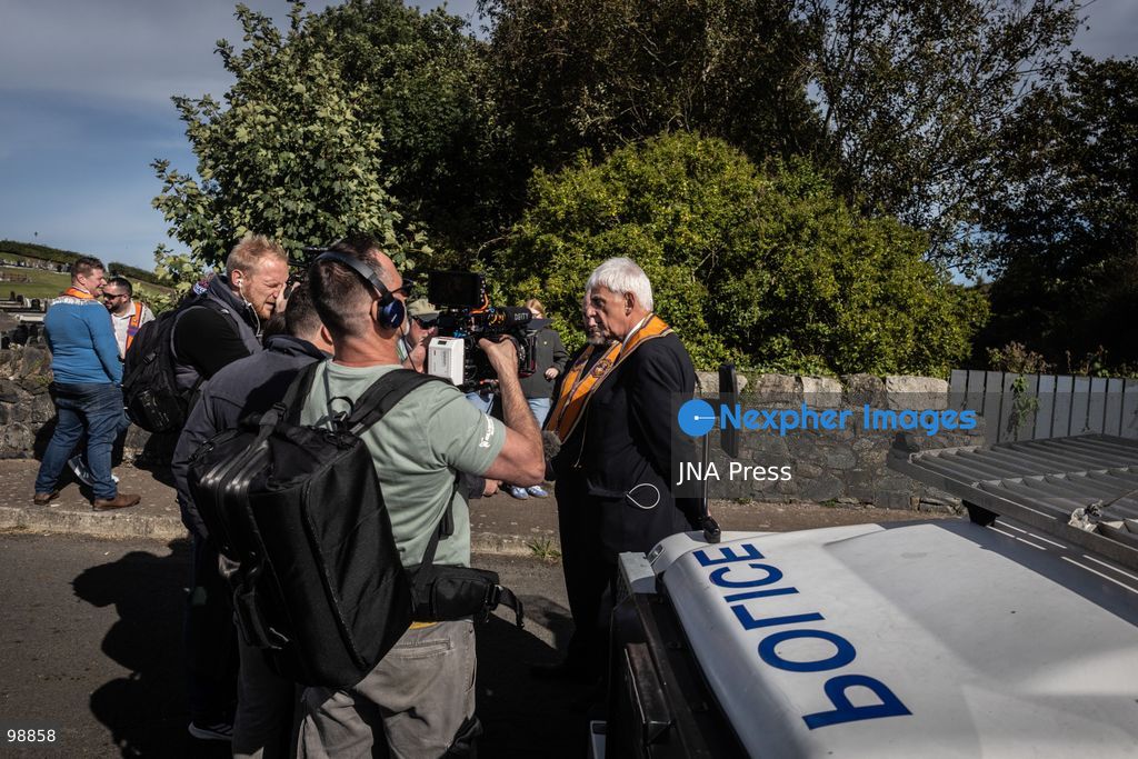 PORTADOWN, NORTHERN IRELAND, SEPTEMBER 28, 2026: Members of the Orange Order gather near Drumcree Parish Church as a standoff over the contentious Drumcree parade continues in Portadown. The Protestant fraternal organization had been granted conditional permission to march along the predominantly nationalist Garvaghy Road for the first time in nearly three decades, but the route was blocked by thousands of protesters and police prevented the parade from proceeding amid public safety concerns. On Monday, residents continued gathering on Garvaghy Road while Orange Order members remained near Drumcree Church as discussions continued with police and officials over the dispute. Photo by Nadia Caimi / JNA Press. (Photo by Nadia Caimi/JNA Press via Nexpher Images)