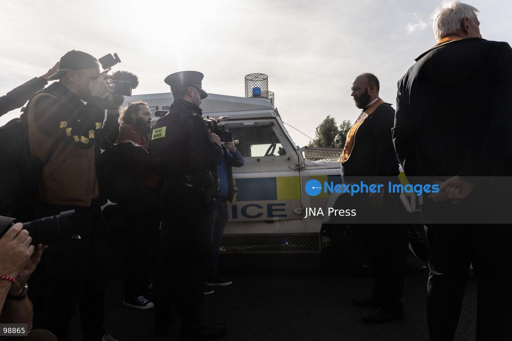 PORTADOWN, NORTHERN IRELAND, SEPTEMBER 28, 2026: Members of the Orange Order gather near Drumcree Parish Church as a standoff over the contentious Drumcree parade continues in Portadown. The Protestant fraternal organization had been granted conditional permission to march along the predominantly nationalist Garvaghy Road for the first time in nearly three decades, but the route was blocked by thousands of protesters and police prevented the parade from proceeding amid public safety concerns. On Monday, residents continued gathering on Garvaghy Road while Orange Order members remained near Drumcree Church as discussions continued with police and officials over the dispute. Photo by Nadia Caimi / JNA Press. (Photo by Nadia Caimi/JNA Press via Nexpher Images)